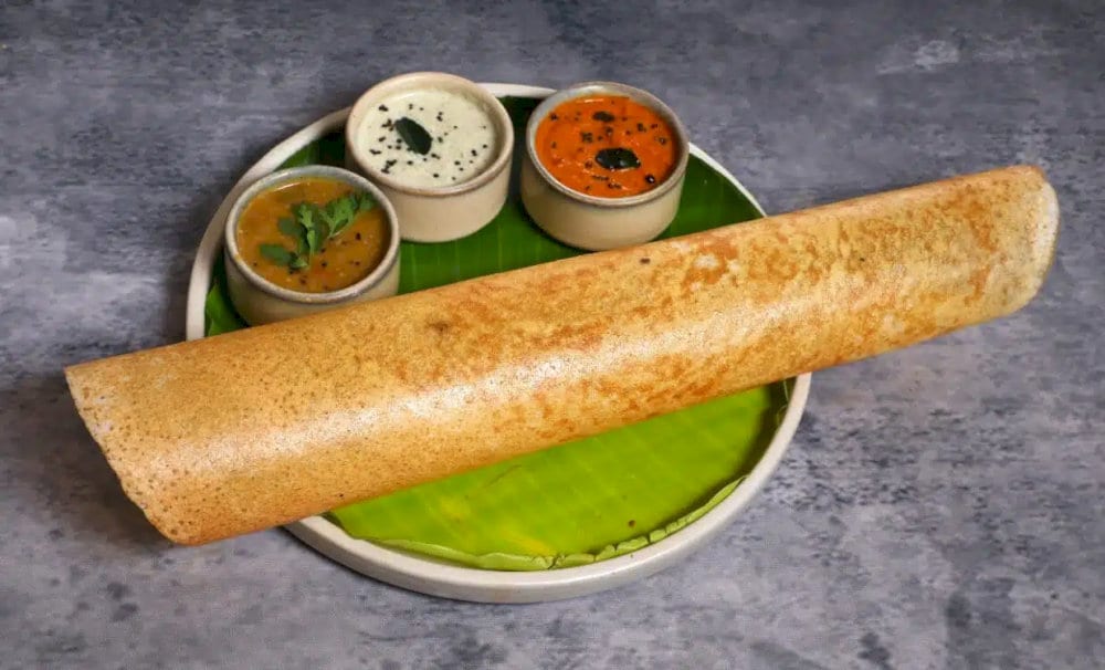 Crispy, light, and savory, dosa is a thin rice pancake often served with tangy chutneys and spicy sambar, offering a perfect breakfast or snack